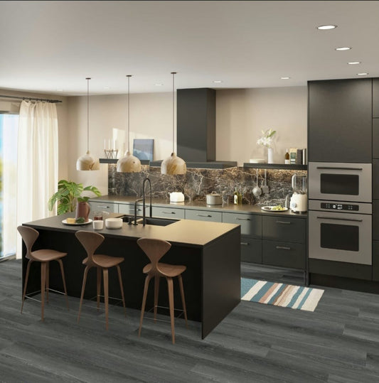 Modern kitchen with black island and slate flooring